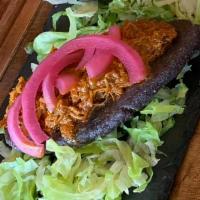 Tlacoyos De Cochinita Pibil · A Tlacoyo is an oval shaped dish. It is made with thick blue corm dough (masa), stuffed with...