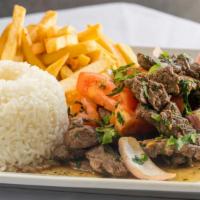 Lomo Saltado · Sauteed beef with onions and tomatoes, served with fries & rice.