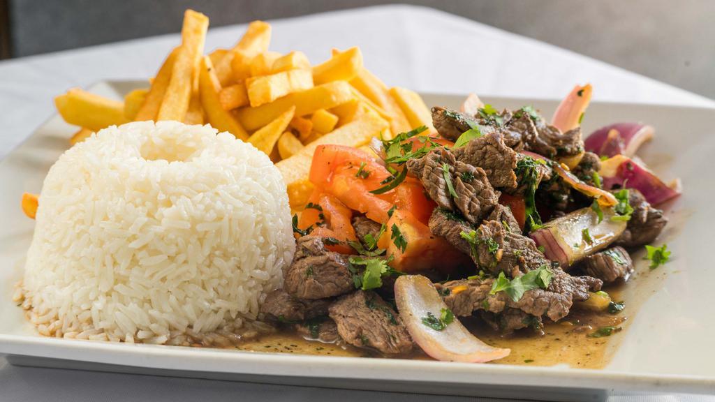 Lomo Saltado · Sauteed beef with onions and tomatoes, served with fries & rice.
