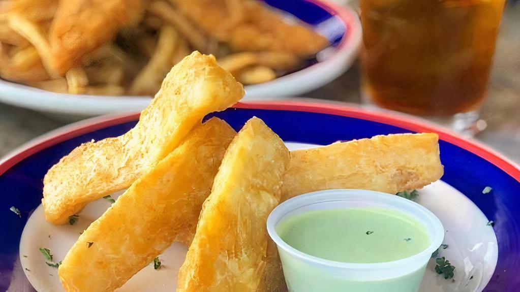 Yuca Frita · Golden-fried cassava served with a dipping cilantro sauce.