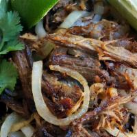 Vaca Frita · Certified Angus beef flank steak pulled and grilled with garlic and onions.