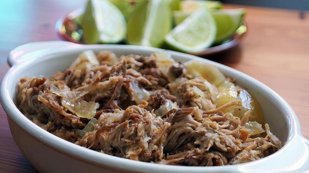 Lechón Asado · Pulled oven roasted pork grilled with onions and garlic mojo sauce.
