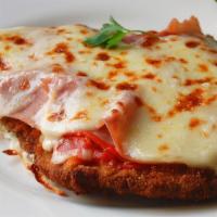 Milanesa De Carne · Breaded sirloin steak topped with ham, tomato sauce, and melted mozzarella.