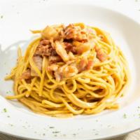 Spaghetti Carbonara · Crispy pancetta, onions, parmesan, and pecorino cheese with whipped eggs.