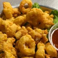 Calamari · Hand-breaded, flash-fried, and served with a sweet and spicy sauce.