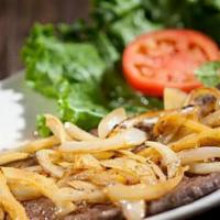 Bistec De Palomilla · Thin cutlet of choice top round steak fully seasoned and grilled to perfection, finished wit...