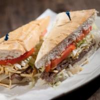 Pan Con Bistec · Thin cutlet of choice top round steak, perfectly seasoned and grilled with sautéed onions, l...