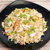 Surf & Turf Fried Rice · Sautéed Shrimp and Chicken Serve with Peas and Carrots, Onion, Scallions, Egg and Thai Jasmi...