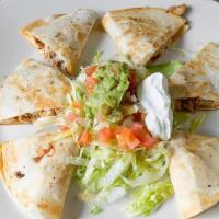 Fiesta Fajita Quesadilla · Tender strips of marinated steak or chargrilled chicken cooked with onions, peppers and toma...