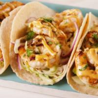 Shrimp Taco (2) · Fried Shrimp topped with pico de Gallo, crema, spicy mayo, and cotija cheese on a corn torti...