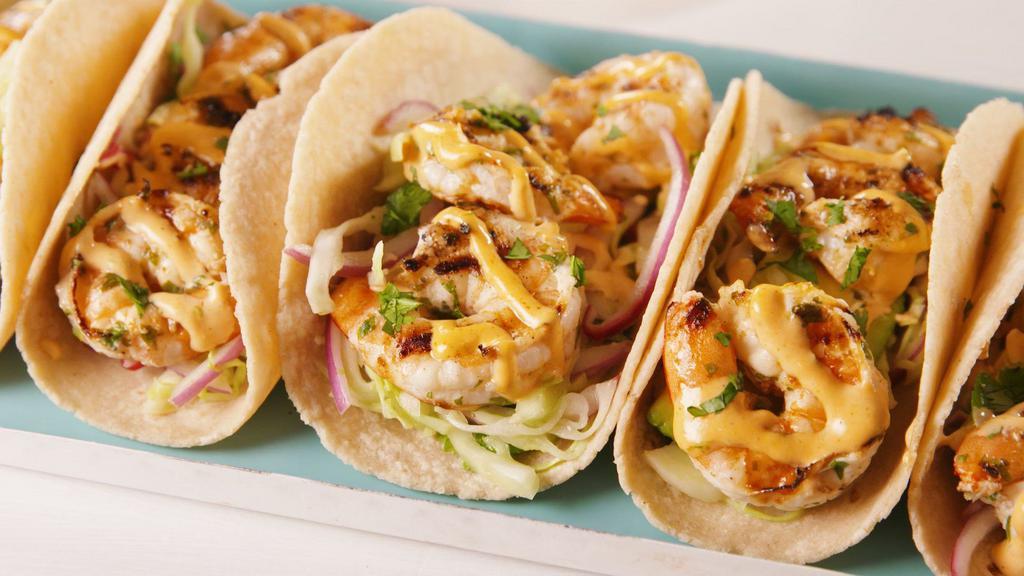 Shrimp Taco (2) · Fried Shrimp topped with pico de Gallo, crema, spicy mayo, and cotija cheese on a corn tortilla