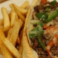 Philly Cheesesteak · Shaved Rib Eye Steak grilled with peppers, onions, and mozzarella cheese Served on a hoagie ...