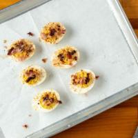 Smoked Datil Deviled Eggs (6 Pcs.) · Served with bacon and scallions on top.