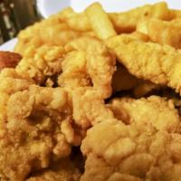 Catfish Dinner Served W/Fries · Crispy mouthwatering Catfish Fillets, served with delicious golden fries and hushpuppies wit...