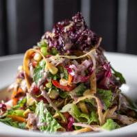 Grilled Chicken Salad · corn, cilantro & tortilla strips tossed in agave lime vinaigrette with a black bean drizzle