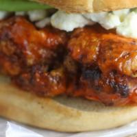 Fire Mouth Chick · Fried Chicken smothered in buffalo sauce, lettuce, tomato, blue cheese sauce served on butte...