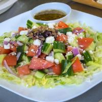 Greek Salad · Cucumber, tomatoes, red onion, olives, & feta dressed with our homemade Greek vinaigrette.
