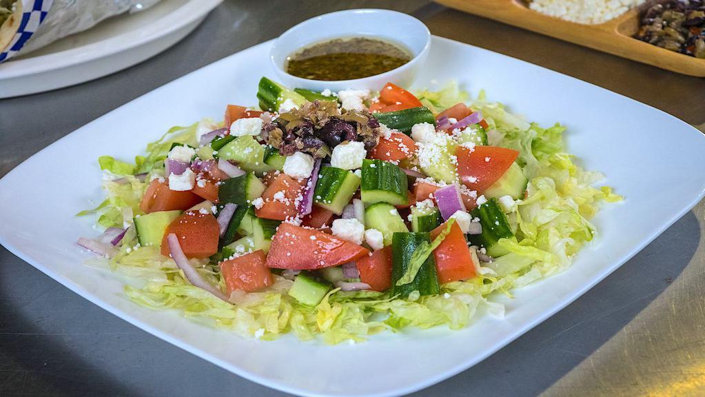 Greek Salad · Cucumber, tomatoes, red onion, olives, & feta dressed with our homemade Greek vinaigrette.