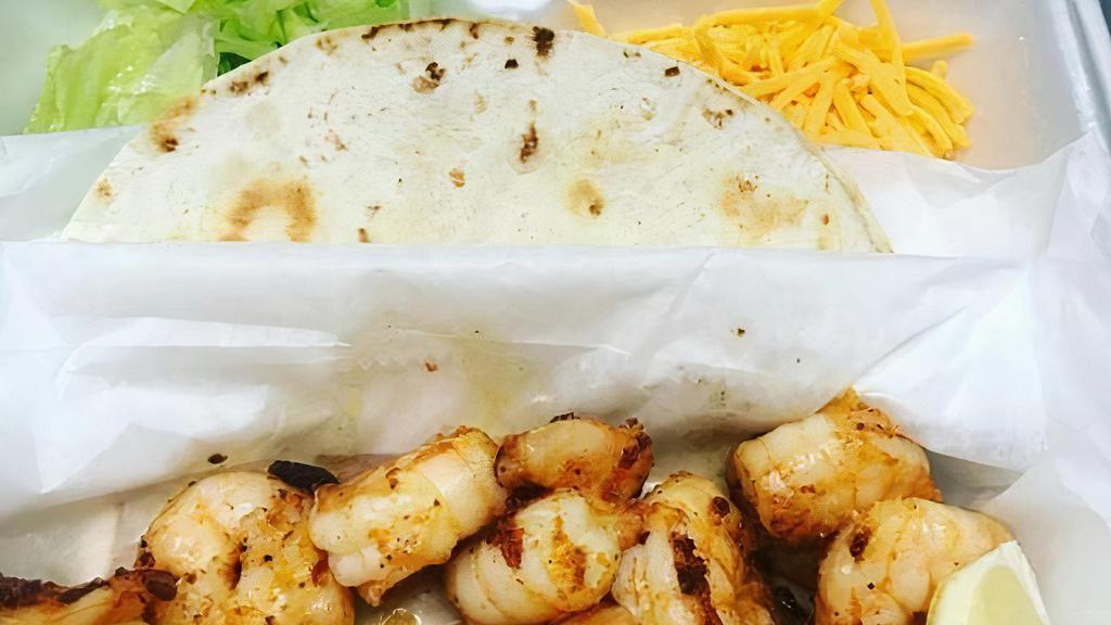 Shrimp Tacos · Build your own tacos with a 1/2 pound of shrimp fried or grilled, three flour shells, crisp lettuce, shredded cheese, tomatoes, sour cream, slaw, and our house-made remoulade. Flour shell, lettuce, cheese, tomatoes, slaw, sauce, and sour cream.