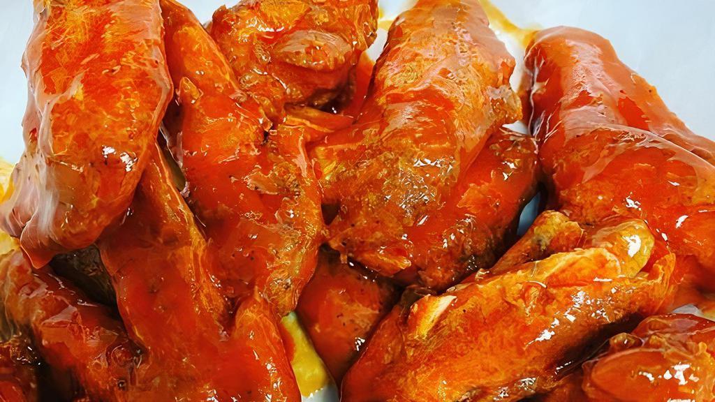Buffalo Wings (12 Pcs) · Hand-cut pieces tossed in a spicy buffalo sauce with fries, dinner roll, and choice of ranch or bleu cheese.