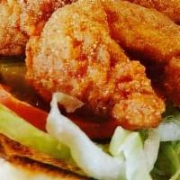 Shrimp Po-Boy · Served on fresh French bread, crispy lettuce, pickles, tomatoes, and housemade remoulade sau...