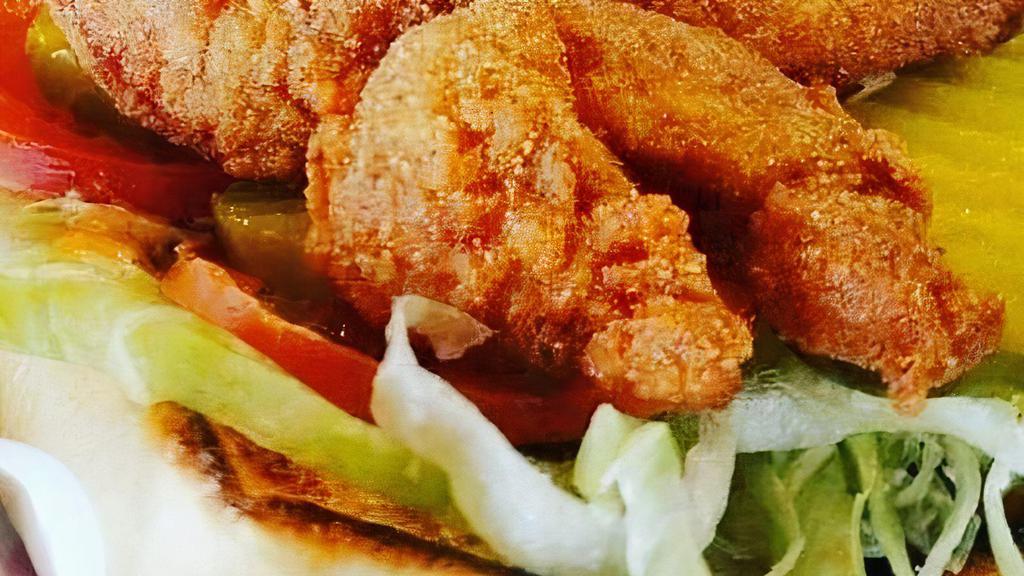 Shrimp Po-Boy · Served on fresh French bread, crispy lettuce, pickles, tomatoes, and housemade remoulade sauce. Fries included.