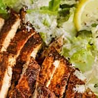 Chicken Caesar Salad · Romaine lettuce tossed in a creamy Caesar dressing, topped with grilled chicken, croutons an...