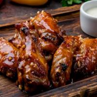 Chicken Wings With Bbq Sauce · 10 pieces of Crispy Boneless Chicken wings fried to perfection and served with a zesty BBQ s...