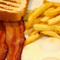 American Breakfast · Two eggs any style with bacon or ham, french fries, and toast.