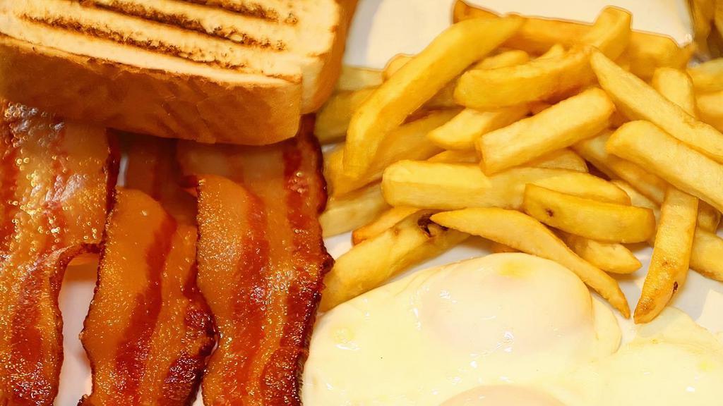 American Breakfast · Two eggs any style with bacon or ham, french fries, and toast.