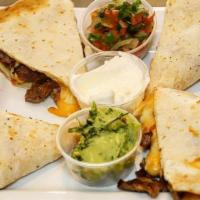 Quesadillas De Carne · Steak quesadilla. Steak grilled at the moment and melted monterrey jack cheese. Pico de gall...
