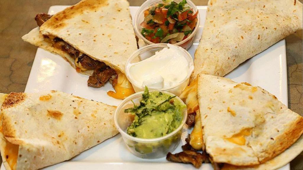 Quesadillas De Carne · Steak quesadilla. Steak grilled at the moment and melted monterrey jack cheese. Pico de gallo, guacamole, and sour cream on the side.