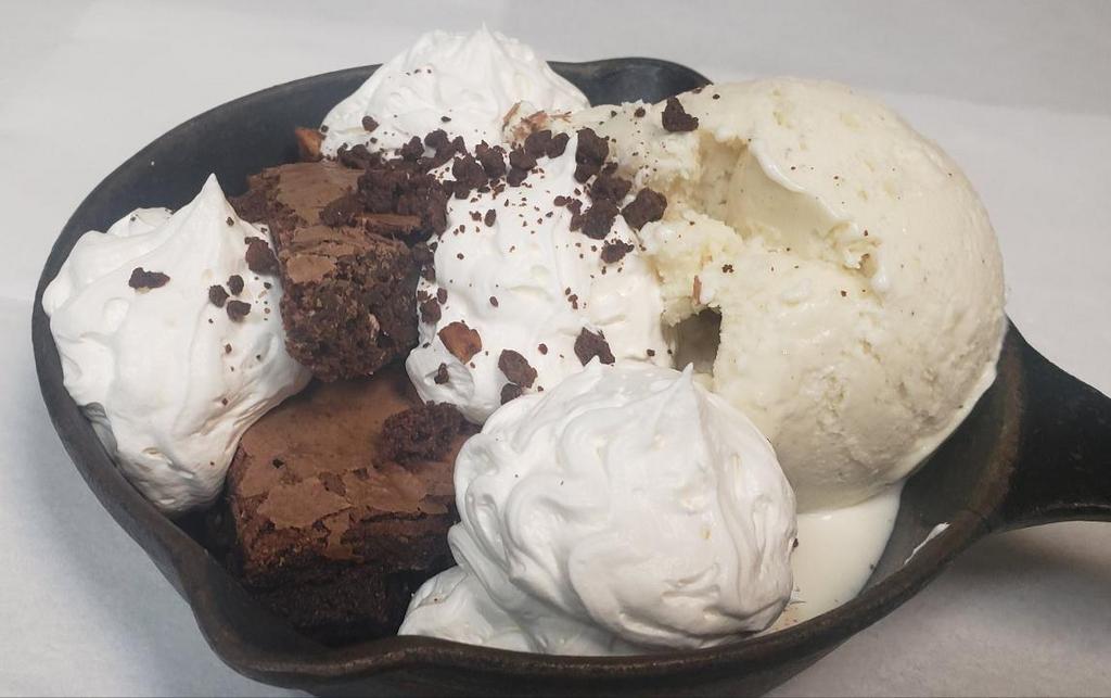 Brownie A La Mode · Fudgy chocolate brownie, vanilla ice cream, chocolate & carmel sauce. Topped with whipped cream