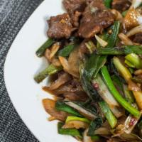 Mongolian Beef / 蔥爆牛 · Beef stir fry with hot pepper and onion, scallion in brown sauce.