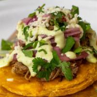 Tostones · Most popular. Three pieces. Tostones fried green plantains topped with ropa vieja shredded b...