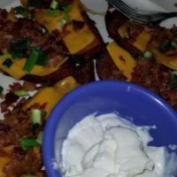 Potato Skins · Served with cheese, bacon, sour cream, and chives.