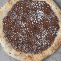 Nutella Pizza · Sweet pizza dough topped with Nutella and powdered sugar.