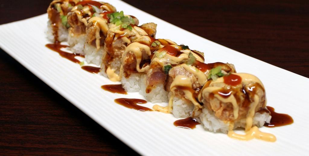 Atomic Bomb Special Raw Roll · Pressed spicy tuna, salmon, and yellowtail seared with spicy mayo, eel sauce hot sauce, and ponzu.