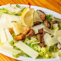Caesar Salad · Romaine lettuce, shaved Parmesan, croutons.