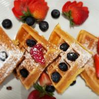 Waffle · Thick Belgian waffle, quartered with warm syrup and powdered sugar. Choose optional toppings.