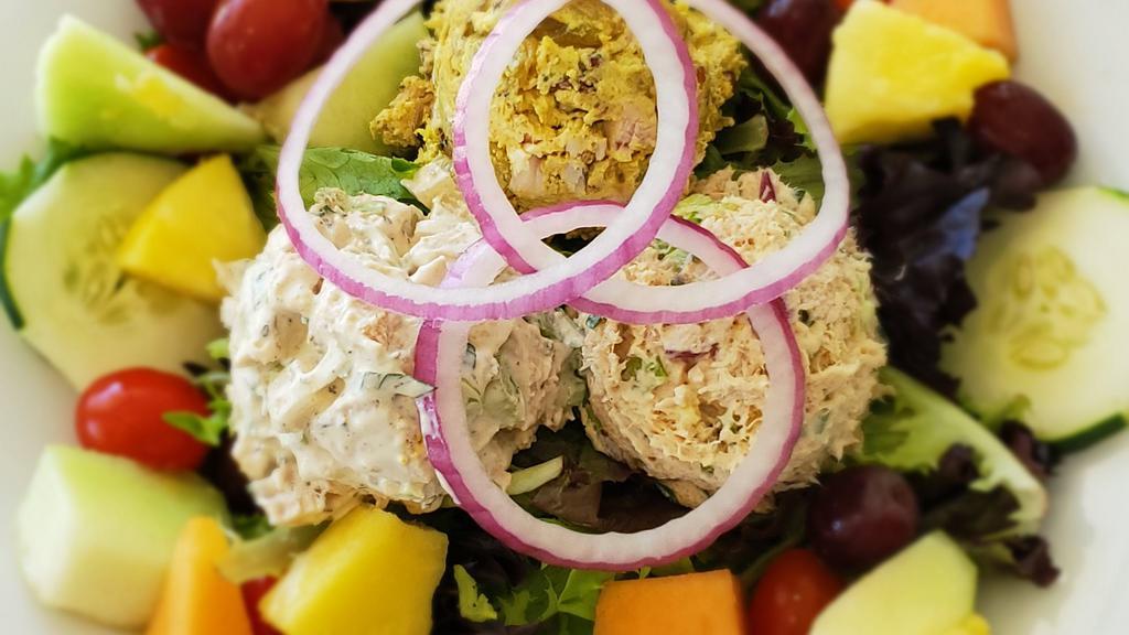 Village Trio · One scoop each of our curry chicken, cafe chicken, and albacore tuna salad served on mixed greens with onion, tomatoes, cucumbers, and fruit.