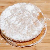 Alfajores · Vanilla cookie filled with dulce de leche and rolled in powdered sugar.