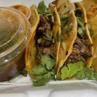 Birria · Three tacos with shredded beef, topped with fresh onion and cilantro. Consome side and hot s...