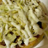 Sope · Thick corn tortilla topped with beans, lettuce, onion, cheese, cream and your favorite prote...