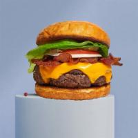 Bacon Burger · American beef patty topped with melted cheese, layers of crispy bacon, lettuce, tomato, onio...