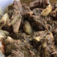 Curry Goat Combo · Marinated with curry and other spices. Served with steamed cabbage, carrots and plantains.