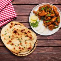 Chicken South Side & Naan Bread · Deep fried small pieces of marinated chicken sauteed in super tangy chilli garlic sauce serv...