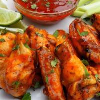 Spicy Chicken Wings (6) · Fried chicken wings drizzled in our signature spicy roasted chili sauce.