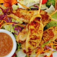 Chicken Satay Salad · Grilled marinated chicken breast on skewers served with mixed greens carrots, tomatoes , cuc...