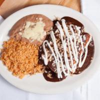 Enchiladas Con Mole (3) · Corn tortillas filled with shredded chicken dipped in mole sauce. (A very traditional sauce ...